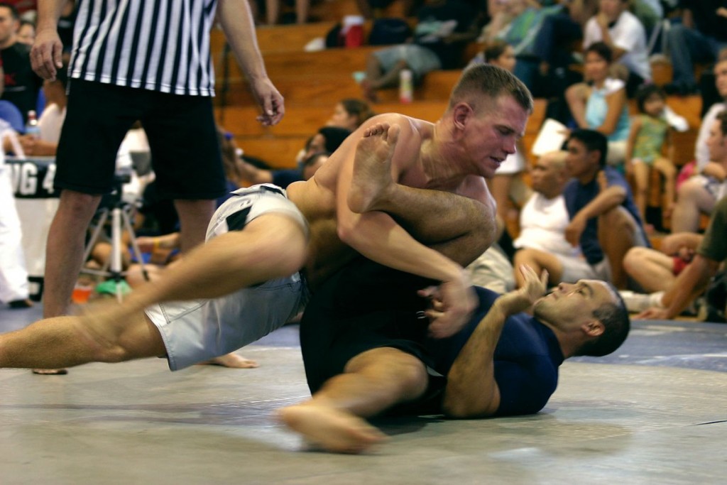 Steven Byrnes, Marine Corps Martial Arts instructor trainer, at K-Bay's Regimental Schools quickly lunges into a dominant position by moving into the side mount on his opponent during the Hawaiian State Grappling Championships.